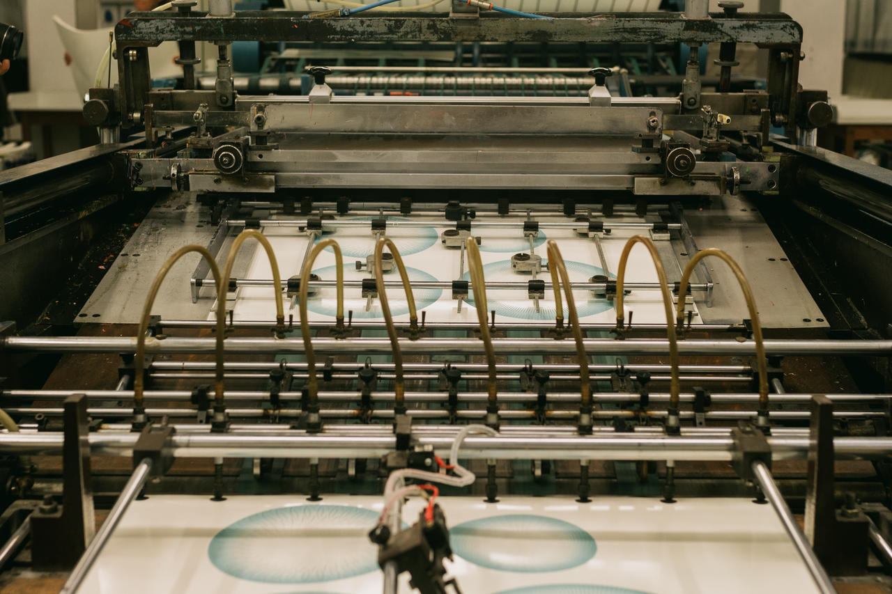 About Close-up of an industrial printing press producing designs.